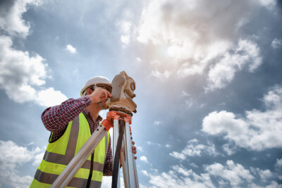 Surveyor&rsquo;s telescope at construction site or Surveying for making contour plans are a graphical representation of the lay of the land before startup construction work